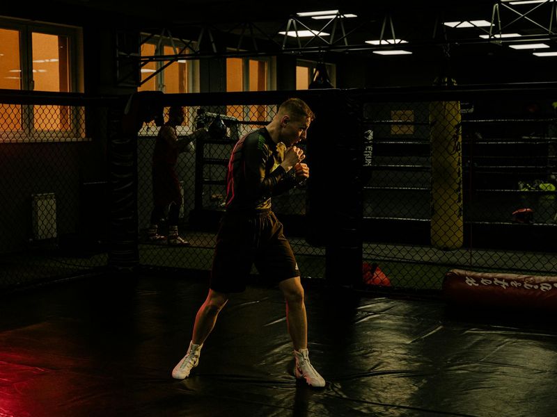 A man focused during a strength training session in a spacious loft.